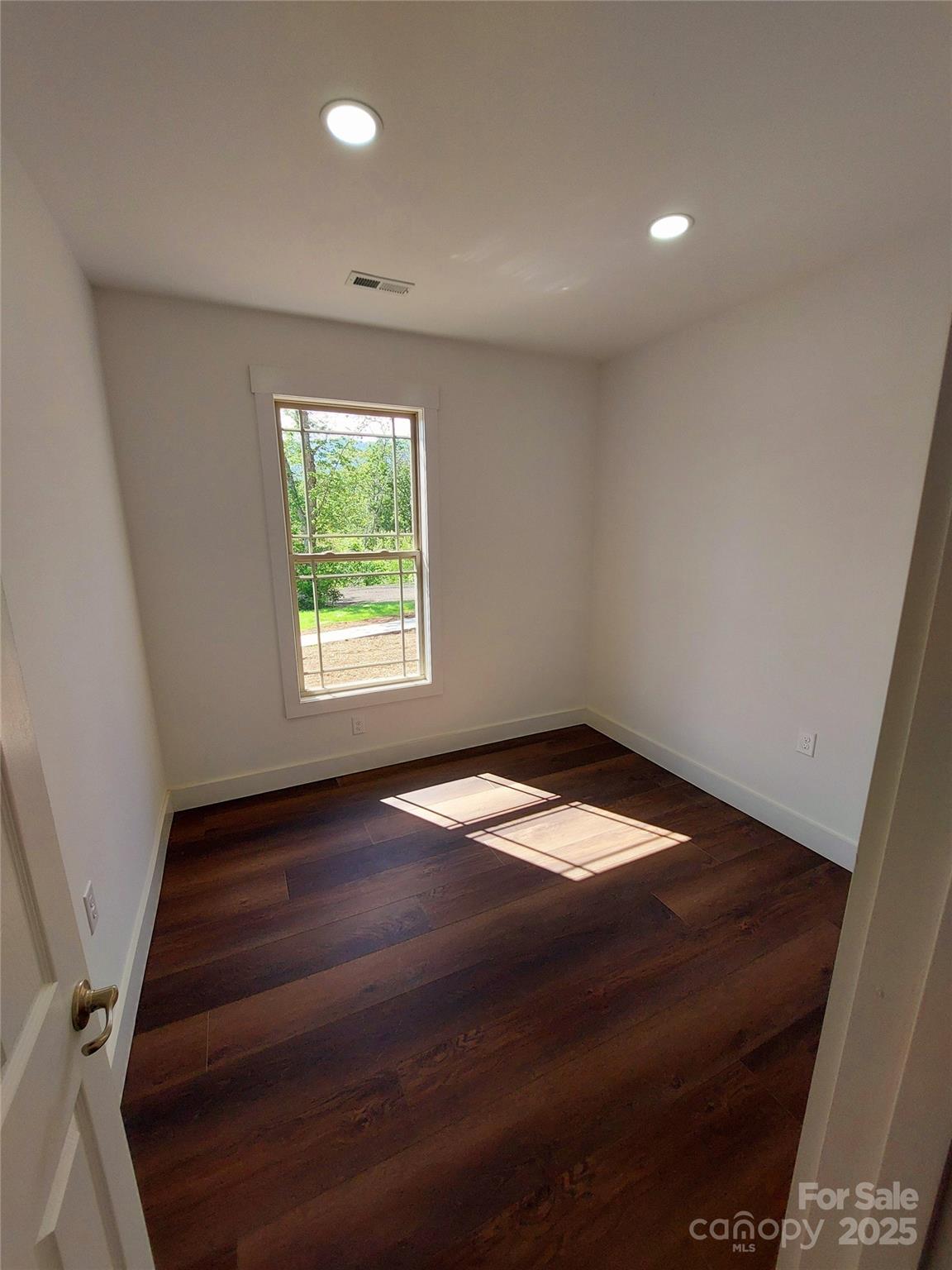 401 Constant Lane Columbus, NC 28722 - Photo 24 of 24 wooden floor in an empty room with a window