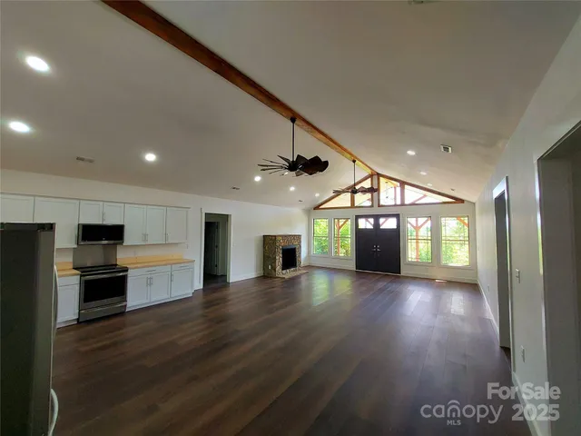 a view of a kitchen with a sink and a stove top oven