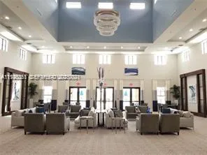 a living room with lots of furniture and chandelier