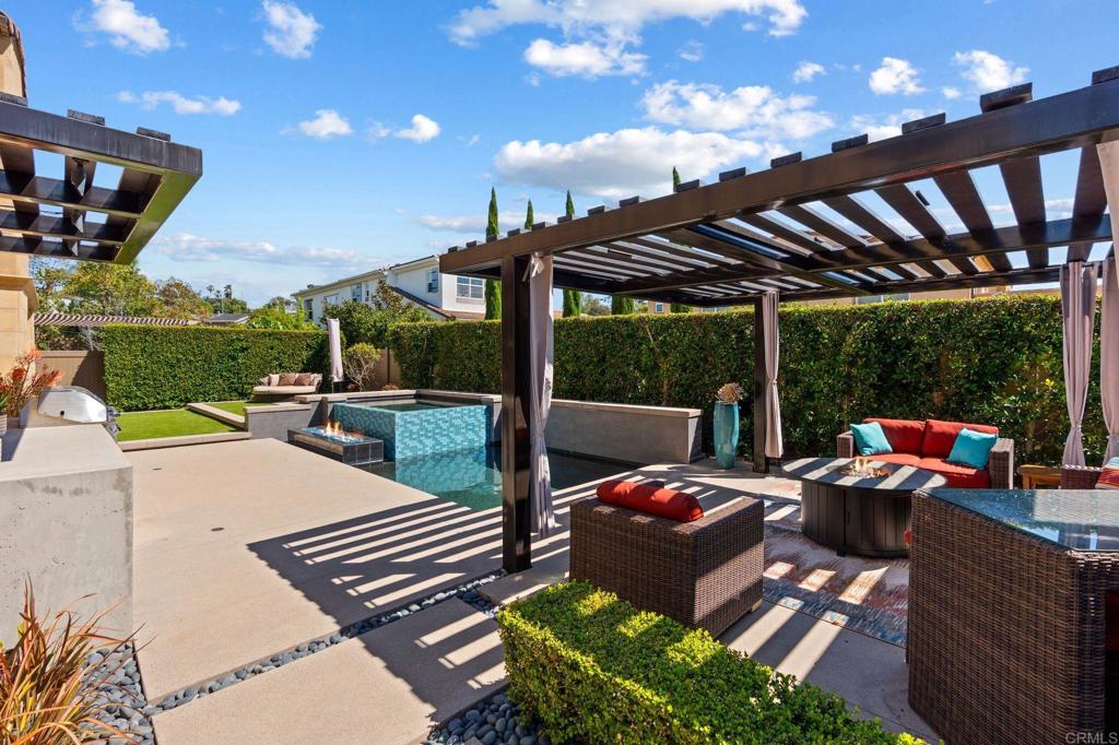809 Dolphin Circle Encinitas, CA 92024 - Photo 53 of 71 a view of a patio with couches table and chairs under an umbrella with a patio