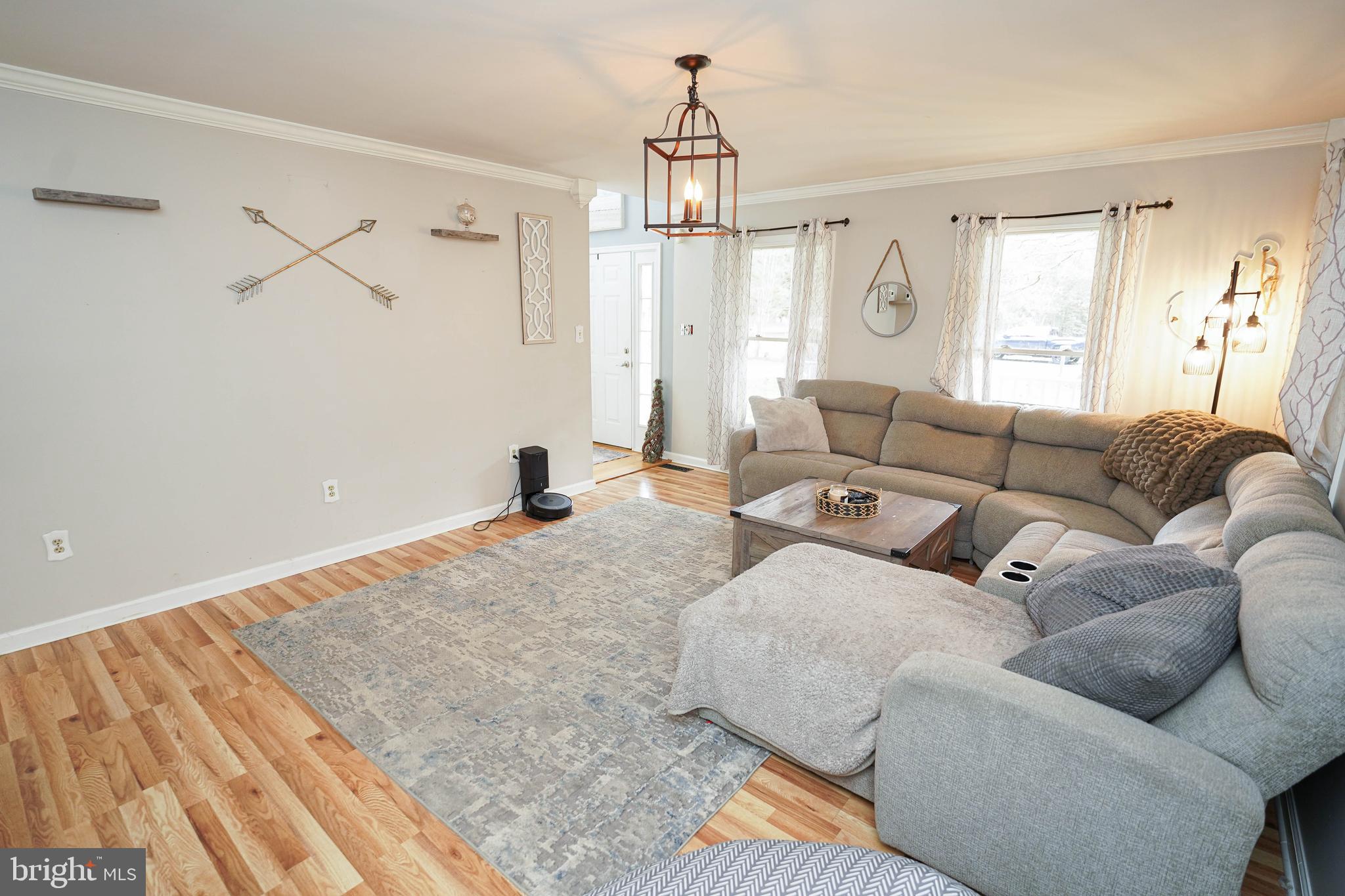 3727 Village Trail Snow Hill, MD 21863 - Photo 11 of 75 a living room with furniture and a chandelier
