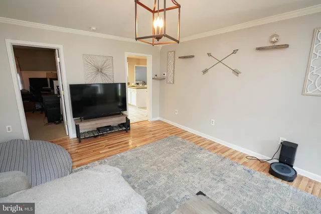 a kitchen with granite countertop white cabinets and refrigerator