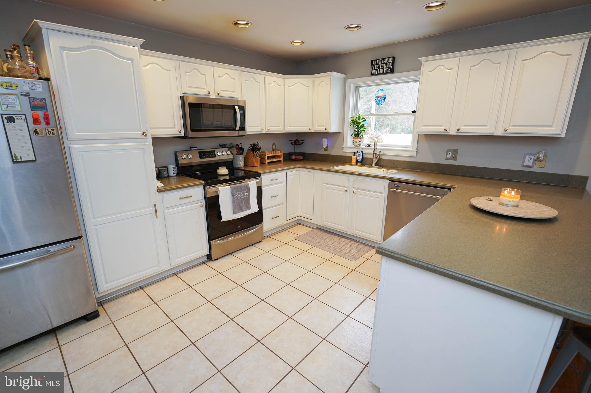 3727 Village Trail Snow Hill, MD 21863 - Photo 16 of 75 a kitchen with granite countertop white cabinets and refrigerator