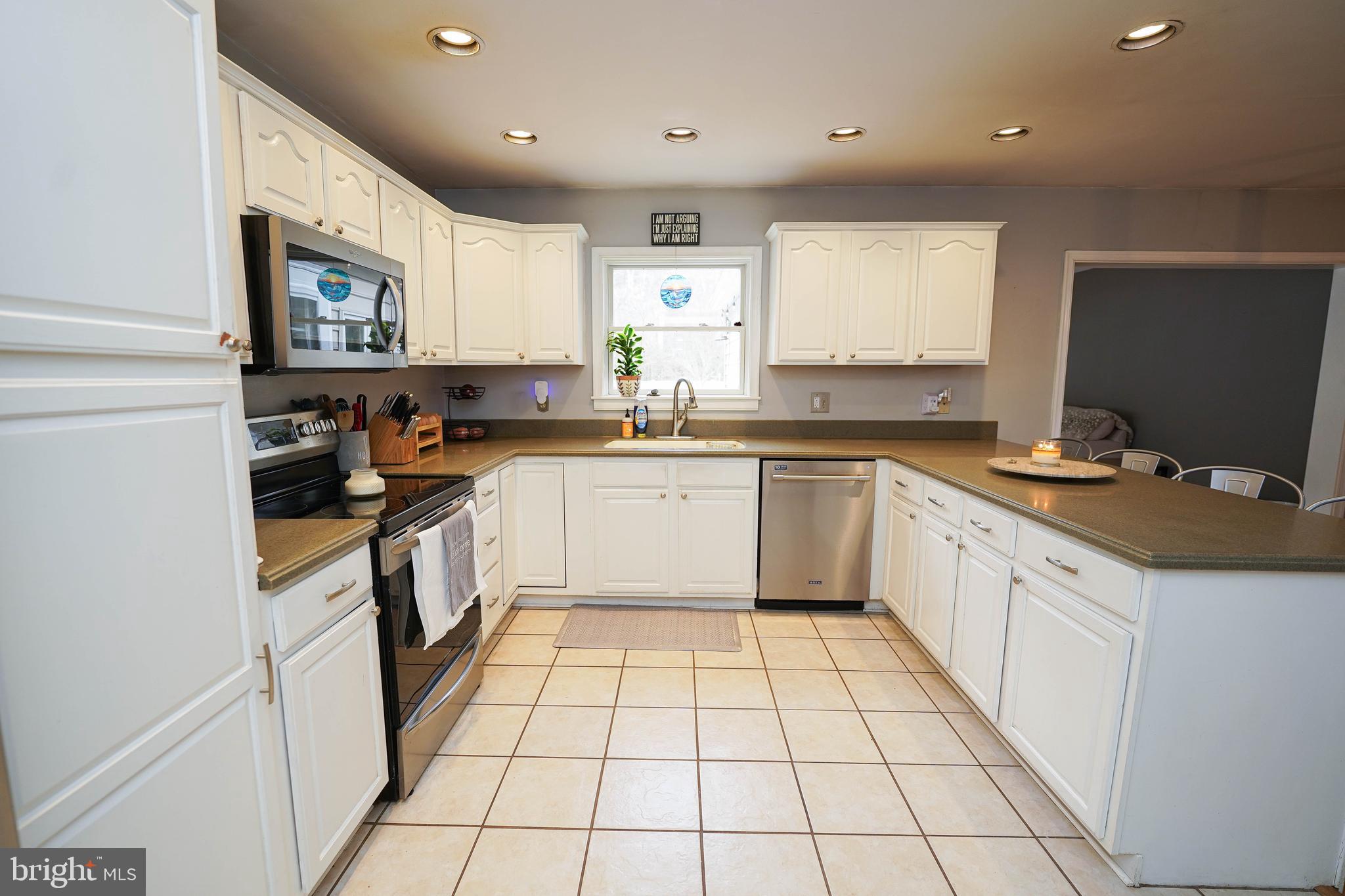 3727 Village Trail Snow Hill, MD 21863 - Photo 17 of 75 a kitchen with a sink a stove top oven and cabinets