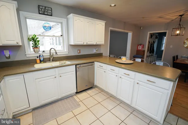 a view of a hallway with furniture and a window