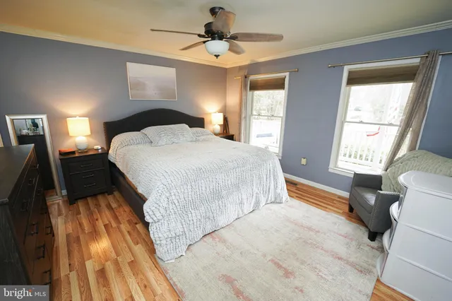 a spacious bedroom with a bed and flat screen tv
