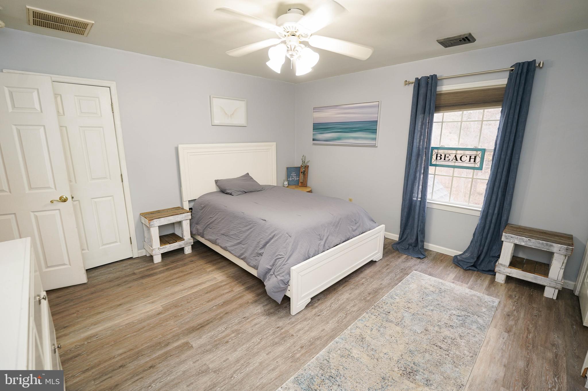 3727 Village Trail Snow Hill, MD 21863 - Photo 48 of 75 a bedroom with a bed and a chandelier