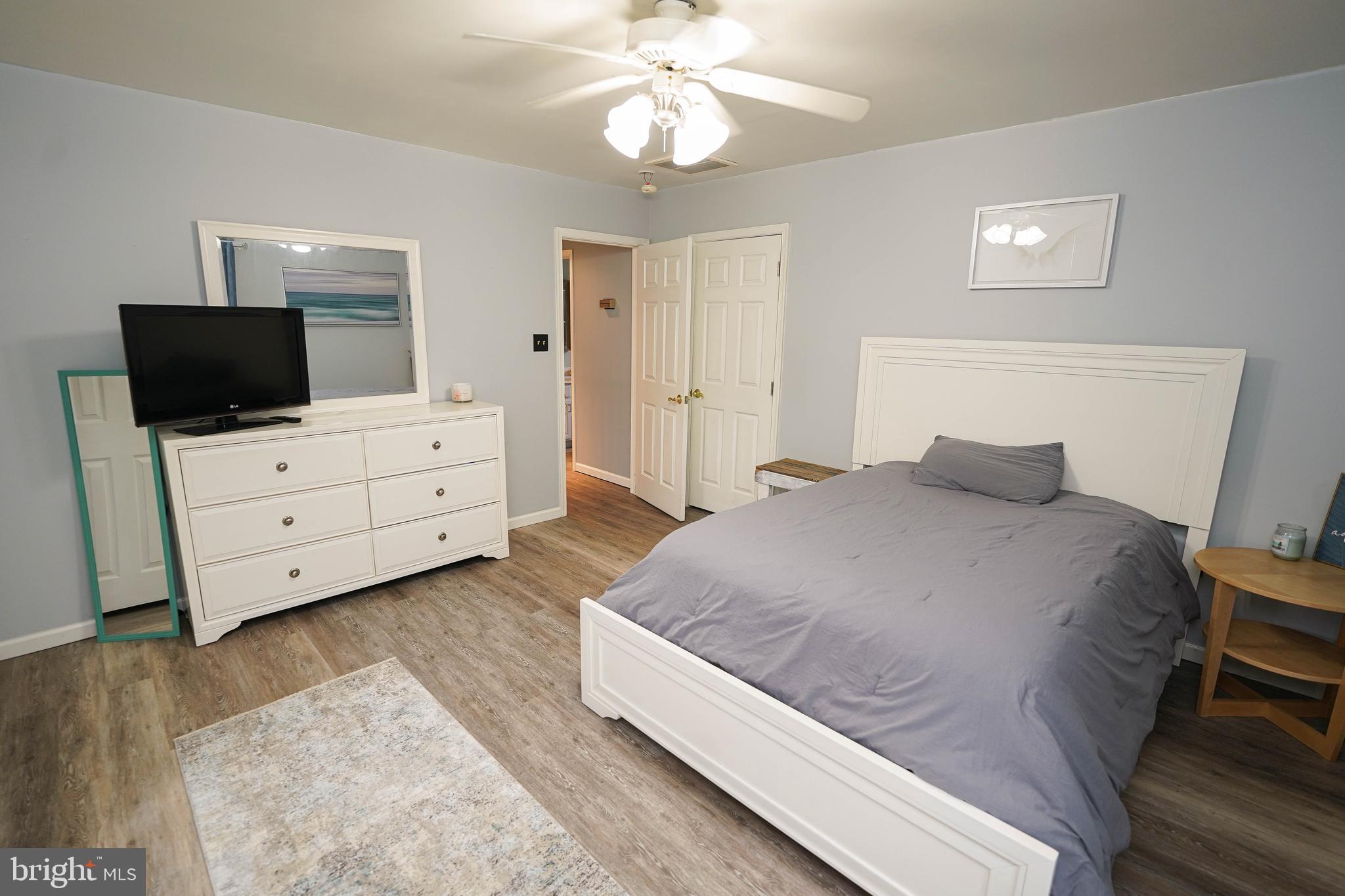 3727 Village Trail Snow Hill, MD 21863 - Photo 49 of 75 a spacious bedroom with a bed and flat screen tv
