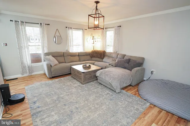 a room with furniture a flat screen tv and gym equipment