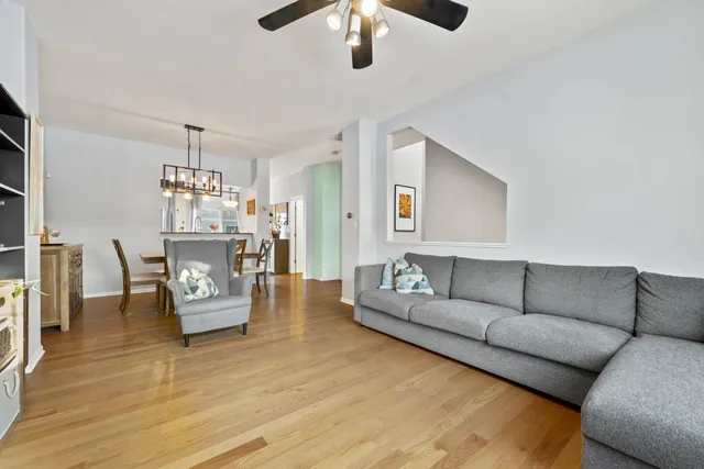 a living room with furniture and a chandelier