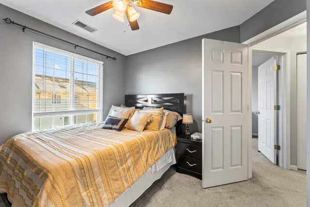 a bedroom with a bed and a window