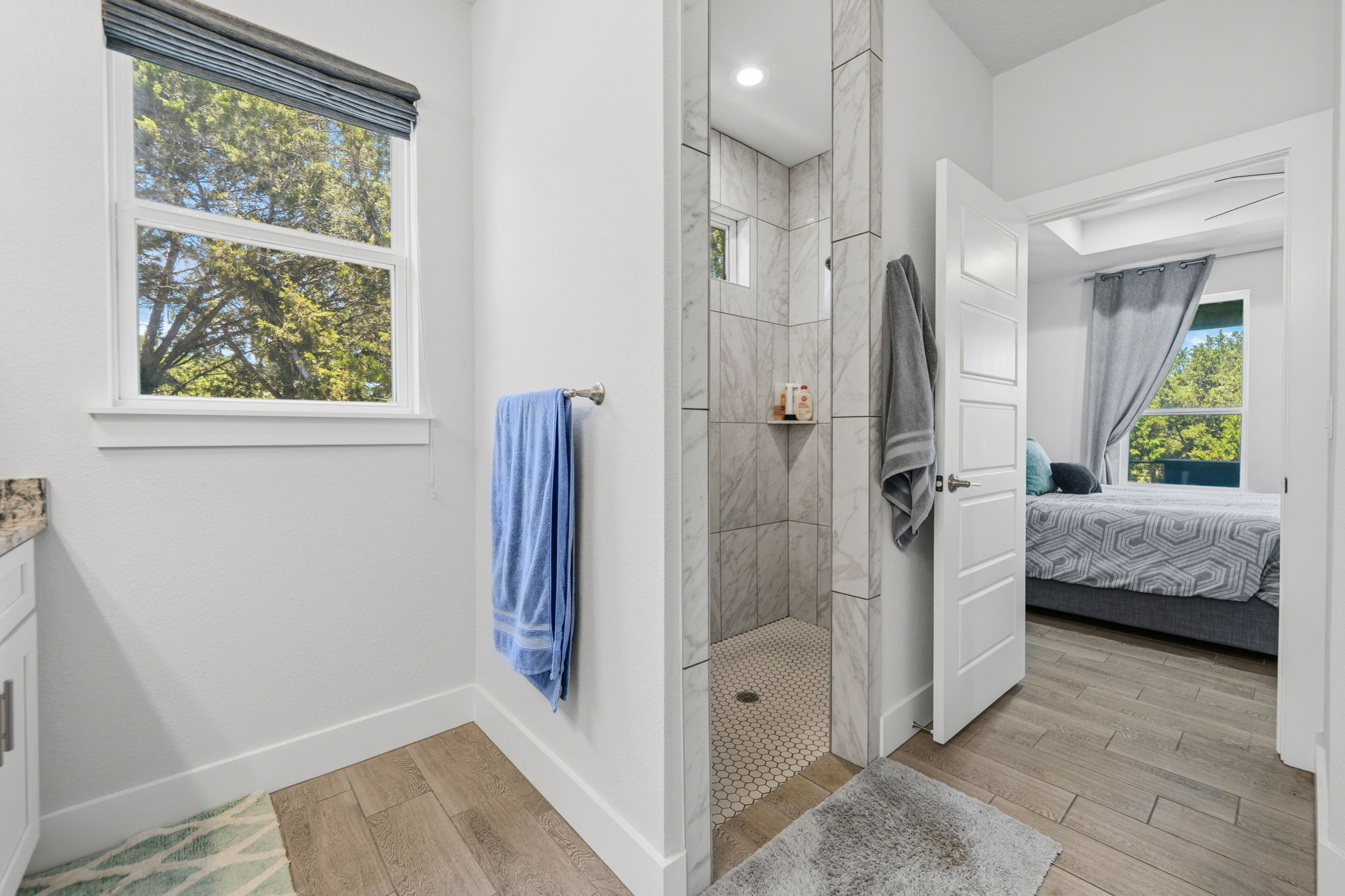 18605 Masters Cove Point Venture, TX 78645 - Photo 20 of 40 Walk-in shower with tiled walls and a hex-tile floor