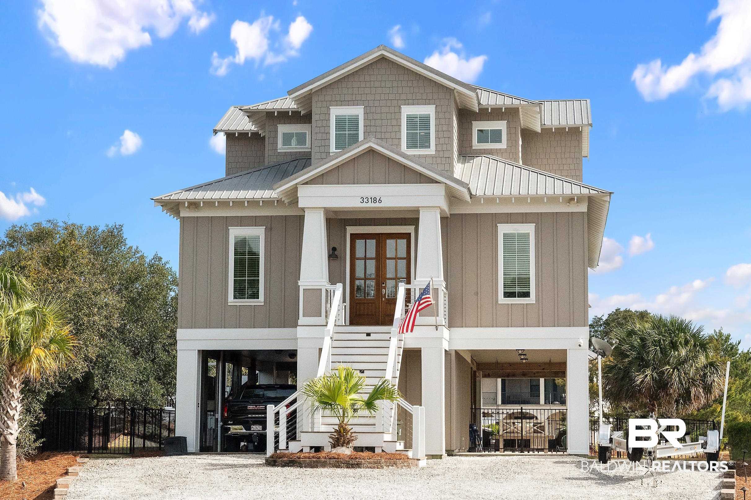 33186 Marlin Key Drive Orange Beach, AL 36561 - Photo 11 of 87 Coastal home featuring french doors, board and batten siding, and a carport