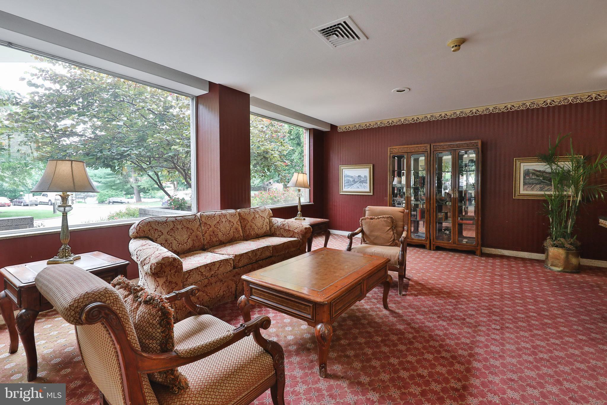 7900 Old York Road, Unit 510B Elkins Park, PA 19027 - Photo 6 of 21 a living room with furniture and a floor to ceiling window
