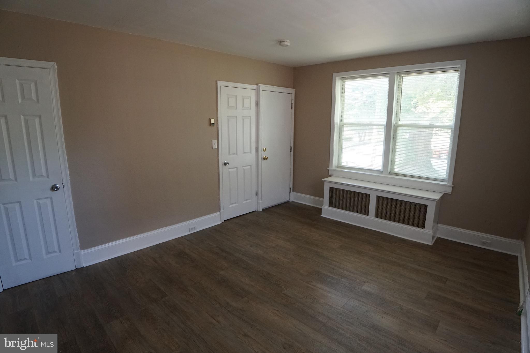2 Aigburth Road, Unit 1 Towson, MD 21286 - Photo 2 of 10 an empty room with wooden floor and windows