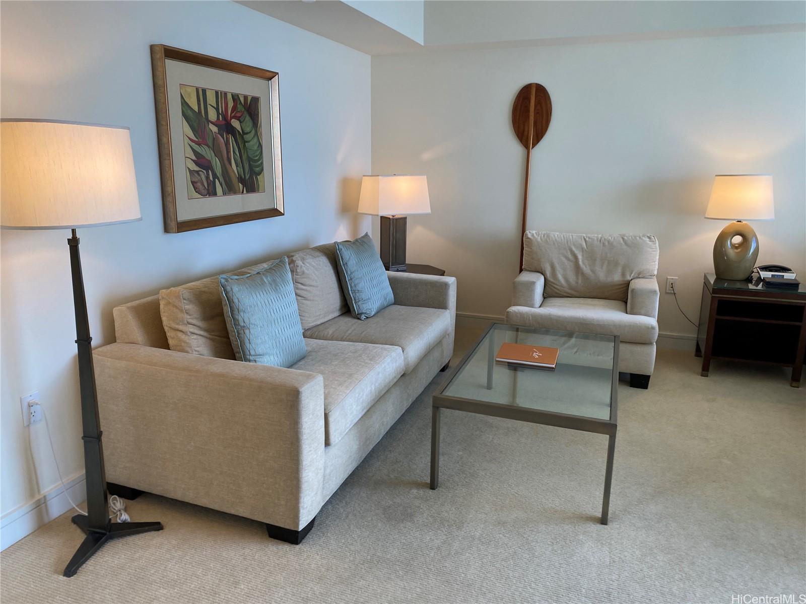 223 Saratoga Road, Unit 2316 Honolulu, HI 96815 - Photo 7 of 20 a living room with furniture and a lamp