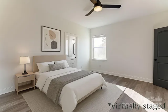 a bedroom with a bed and a painting on the wall