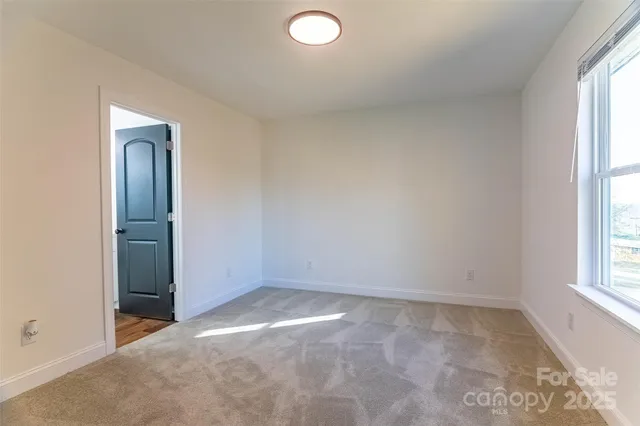 an empty room with windows and closet