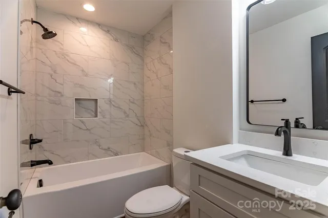 a bathroom with a sink a toilet and a bathtub