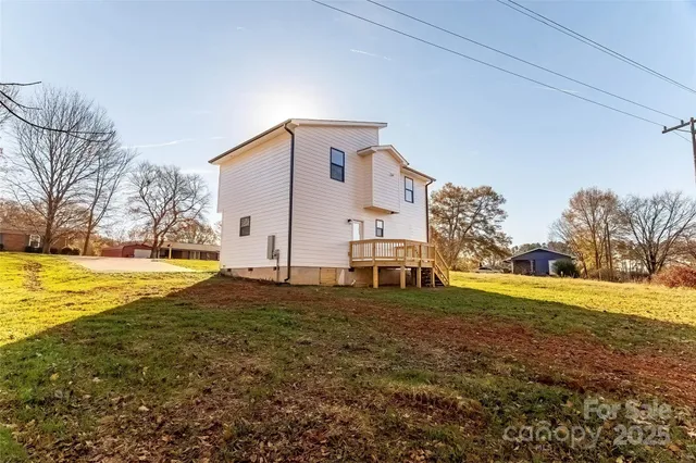 a white house that has a tree in front of it