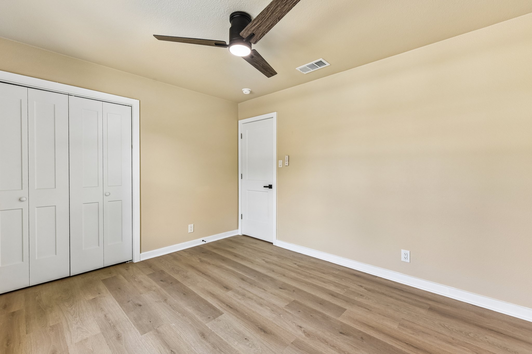 7523 Glenhill Road Austin, TX 78752 - Photo 28 of 38 A quiet retreat with fresh laminate flooring and a modern ceiling fan for ultimate comfort.