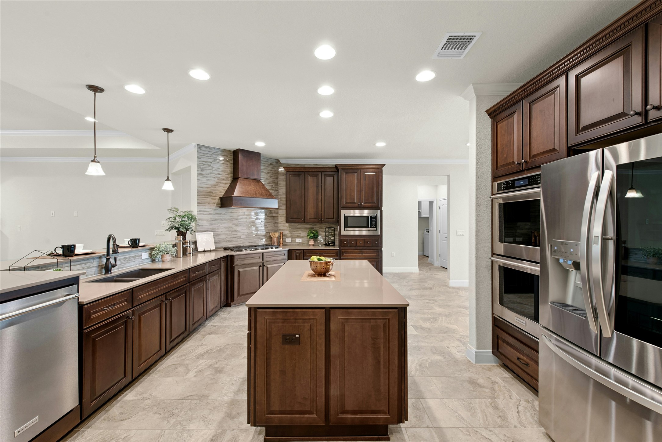 105 Marfa Cove Georgetown, TX 78633 - Photo 10 of 36 a kitchen with kitchen island granite countertop a stove sink and refrigerator