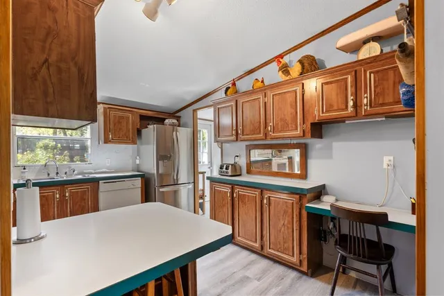 a kitchen with stainless steel appliances granite countertop a stove and cabinets