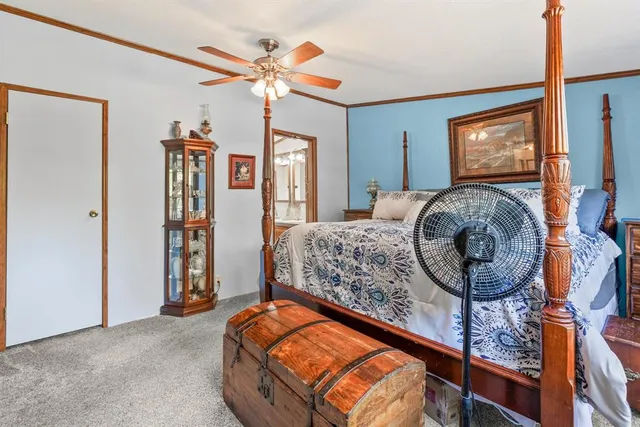 a bedroom with a bed and a chandelier