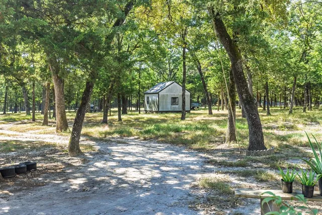a house view with a trees in the background