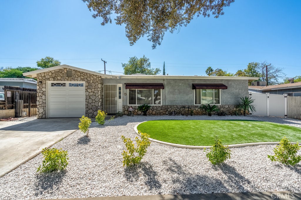 3036 Priscilla Street Riverside, CA 92506 - Photo 1 of 1 a front view of a house with a garden
