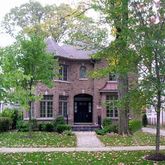 a front view of a house with yard and garden
