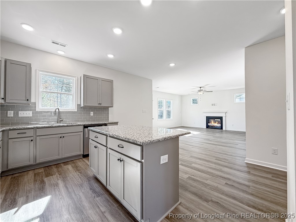 1020 Alex Baker (lot 9) Road Raeford, NC 28376 - Photo 12 of 31 a kitchen that has a lot of cabinets in it and wooden floor