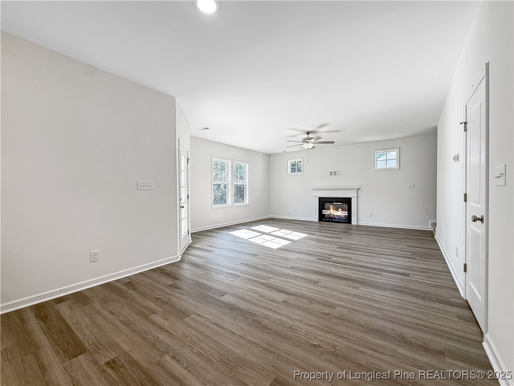 1020 Alex Baker (lot 9) Road Raeford, NC 28376 - Photo 13 of 31 a view of empty room with wooden floor and fireplace