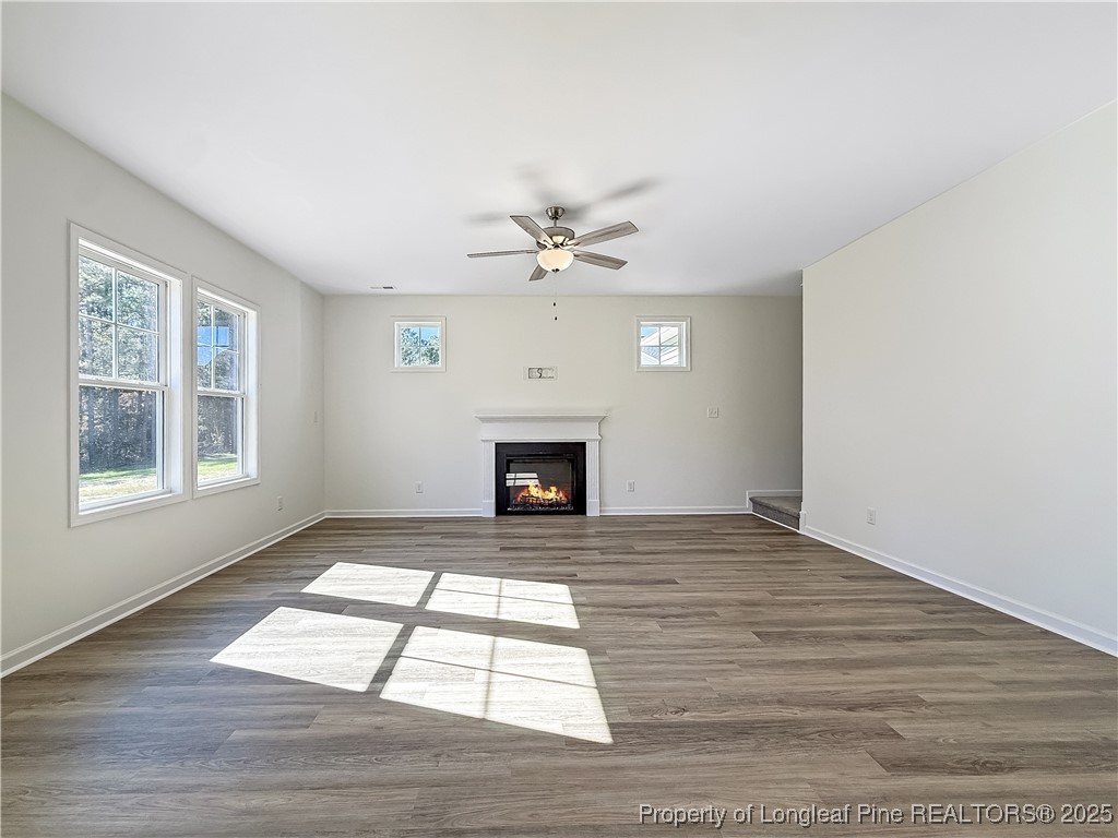1020 Alex Baker (lot 9) Road Raeford, NC 28376 - Photo 14 of 31 a view of an empty room with wooden floor fireplace and a window