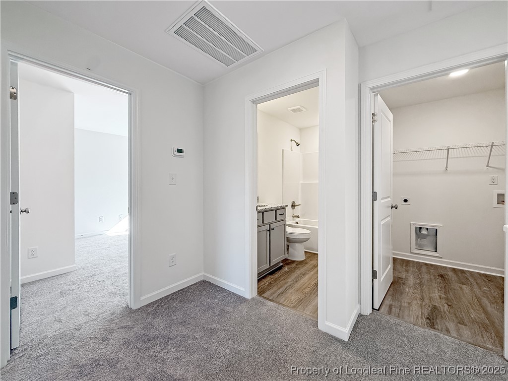 1020 Alex Baker (lot 9) Road Raeford, NC 28376 - Photo 18 of 31 an empty room with wooden floor and a bathroom