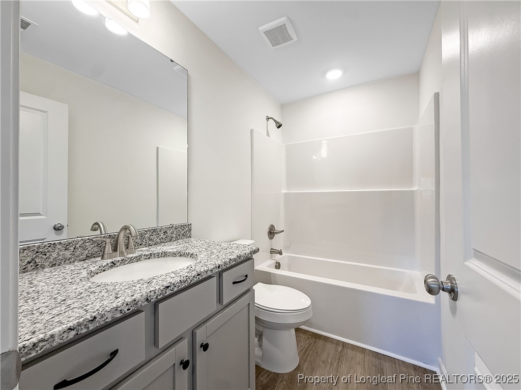 1020 Alex Baker (lot 9) Road Raeford, NC 28376 - Photo 21 of 31 a bathroom with a granite countertop sink a toilet and shower