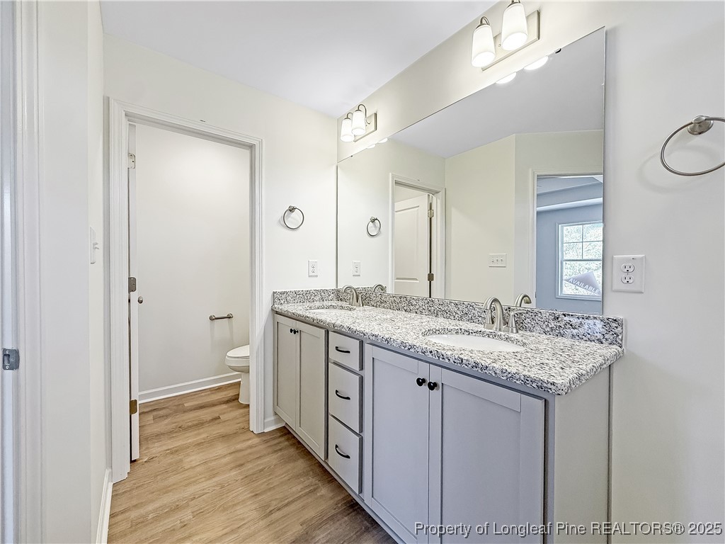 1020 Alex Baker (lot 9) Road Raeford, NC 28376 - Photo 27 of 31 a bathroom with a granite countertop sink and a mirror