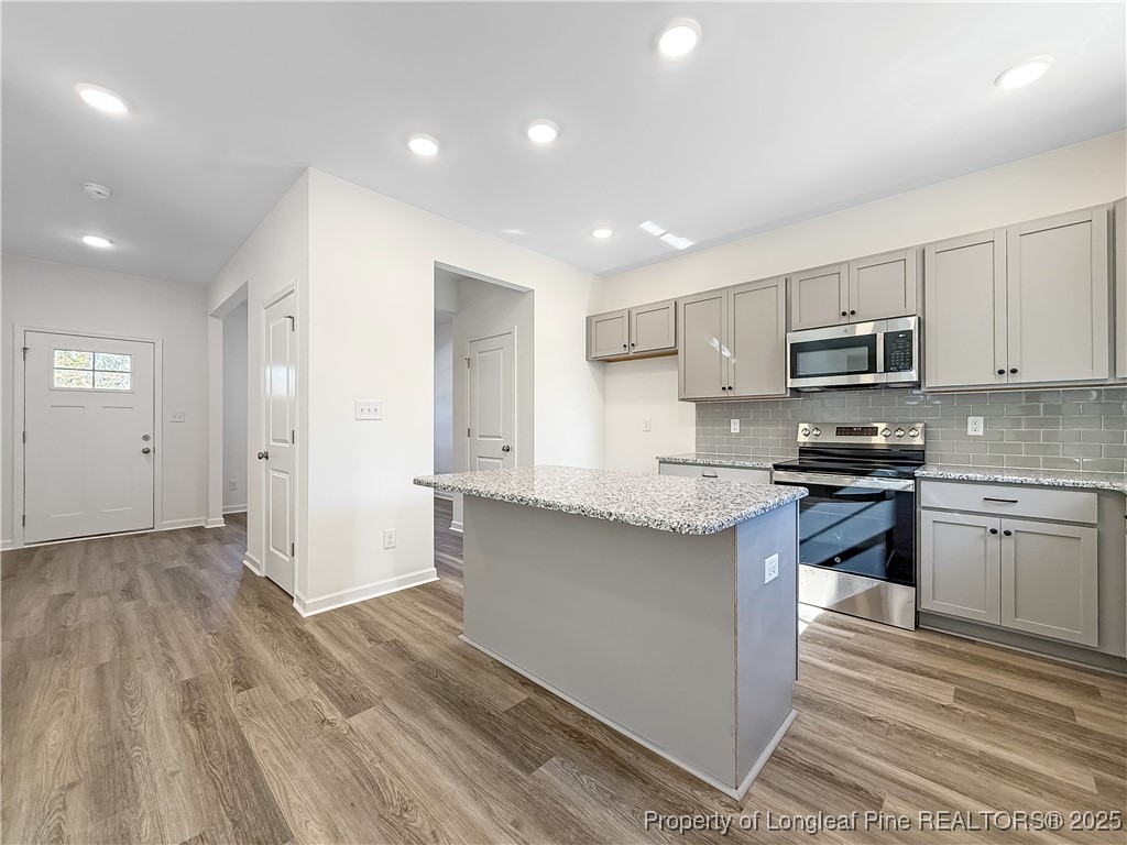1020 Alex Baker (lot 9) Road Raeford, NC 28376 - Photo 8 of 31 a kitchen with granite countertop stainless steel appliances and wooden cabinets