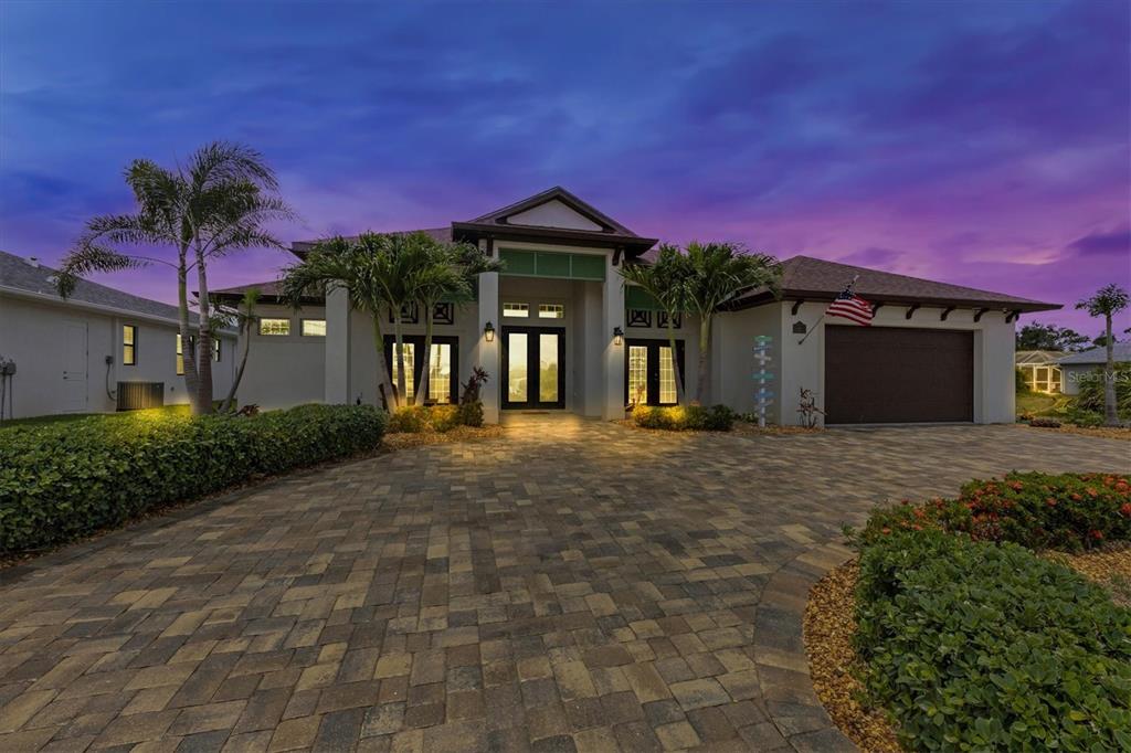 80 Tournament Road Rotonda West, FL 33947 - Photo 1 of 1 a front view of a house with a yard and garage