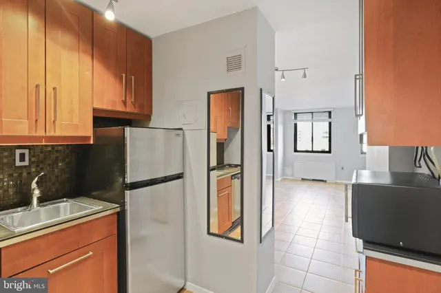 a kitchen with a refrigerator and cabinets