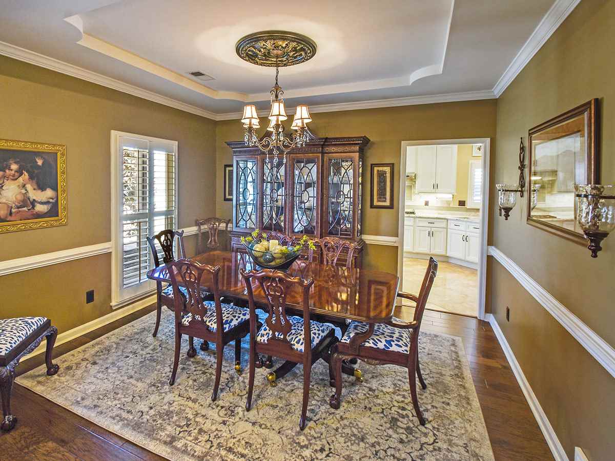 1714 John Ridge Drive Collierville, TN 38017 - Photo 3 of 23 Off the entry is a spacious and stunning dining room. This picture highlights the tray ceiling and plantation shutters,which are used throughout the home.