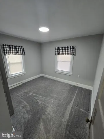 a view of a field with an trees in the background