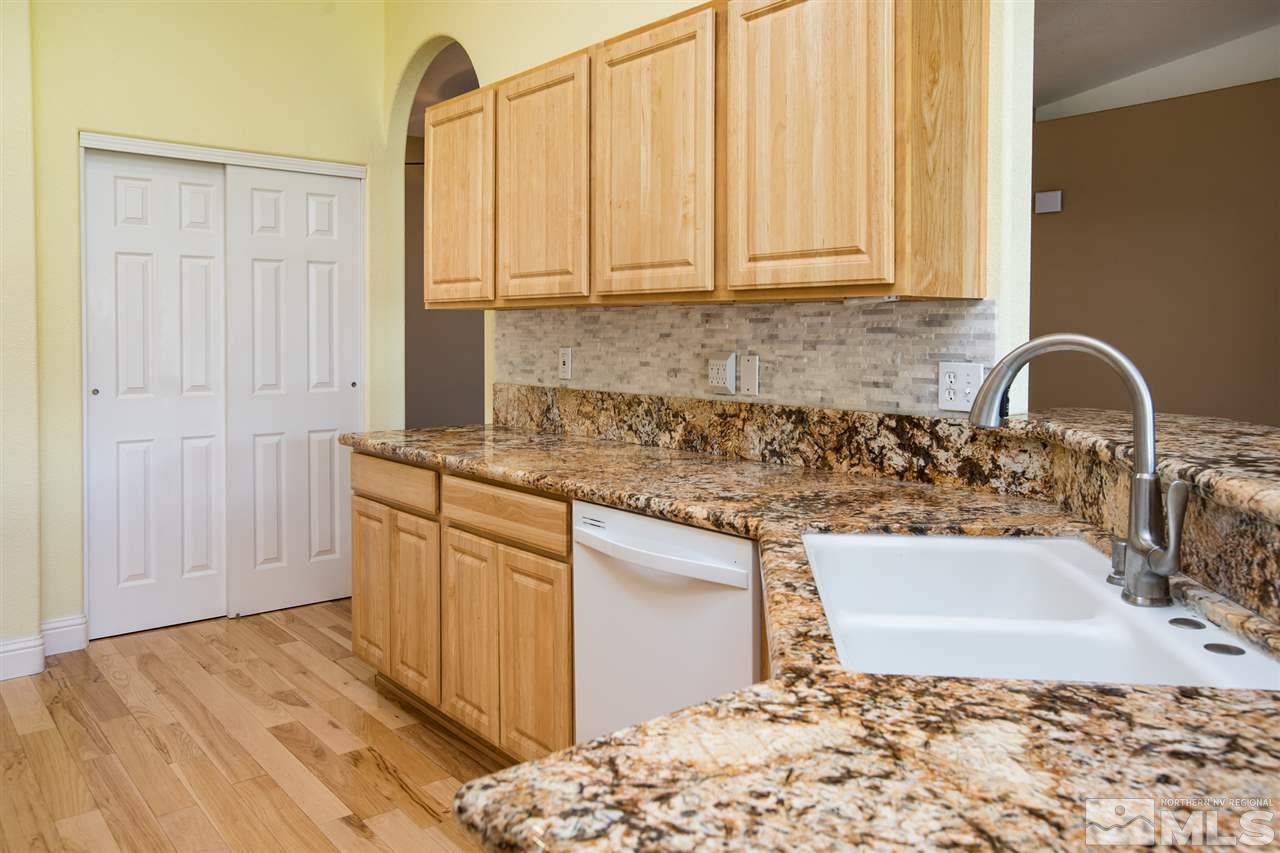 22925 Carriage Drive Reno, NV 89521 - Photo 11 of 24 a kitchen with stainless steel appliances granite countertop a sink and a granite counter tops