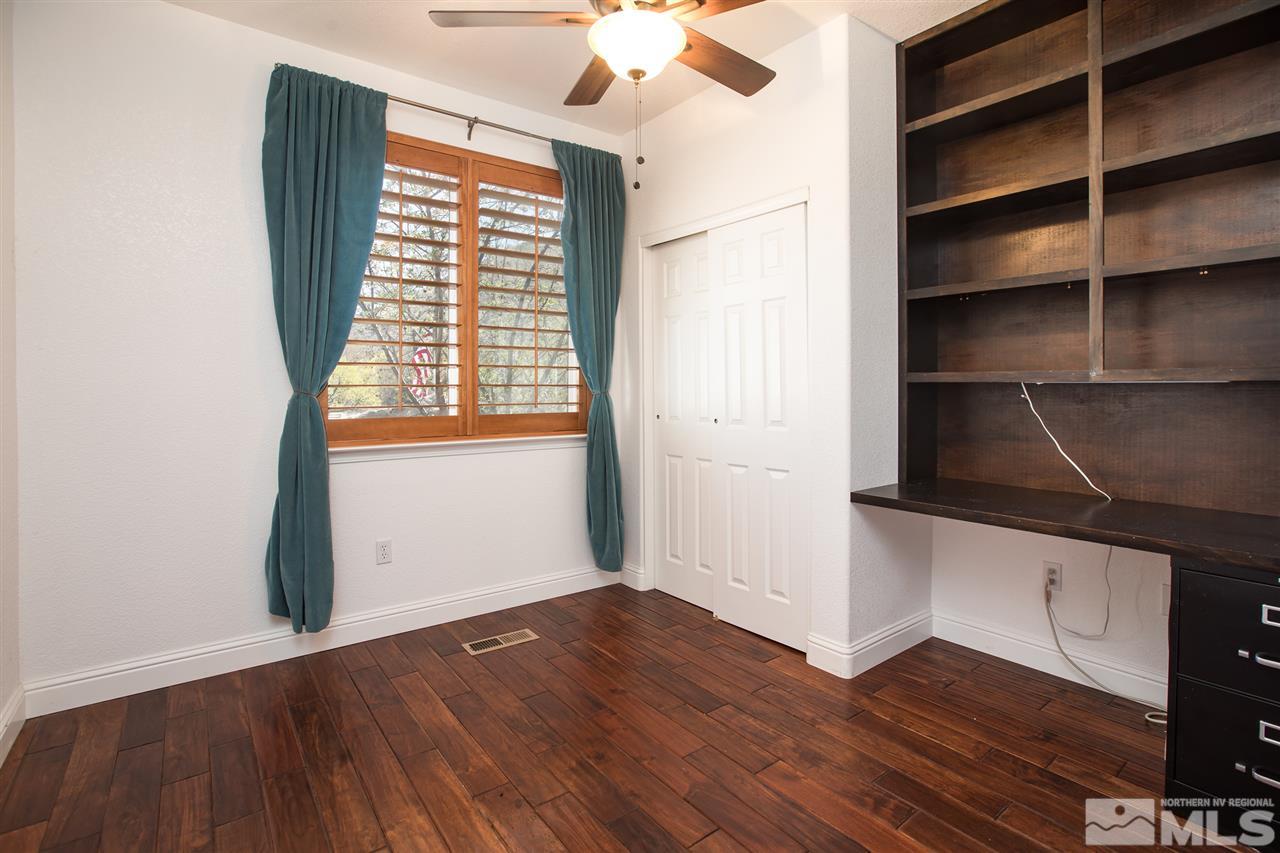 22925 Carriage Drive Reno, NV 89521 - Photo 15 of 24 a view of an empty room with a window and wooden floor