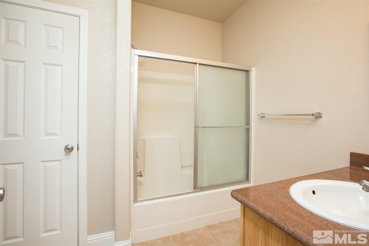 22925 Carriage Drive Reno, NV 89521 - Photo 17 of 24 a bathroom with a tub and shower