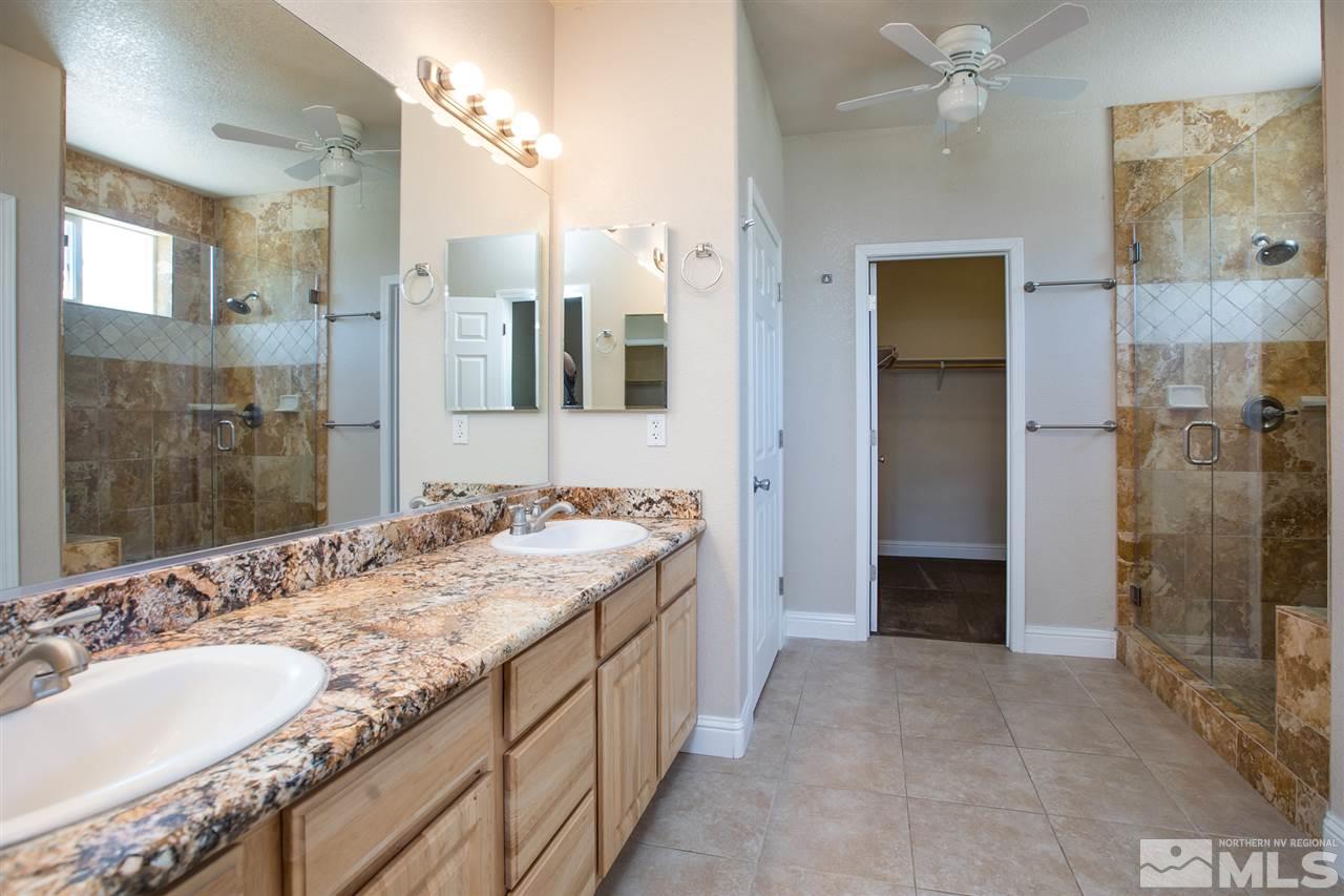 22925 Carriage Drive Reno, NV 89521 - Photo 19 of 24 a spacious bathroom with a granite countertop sink mirror and shower