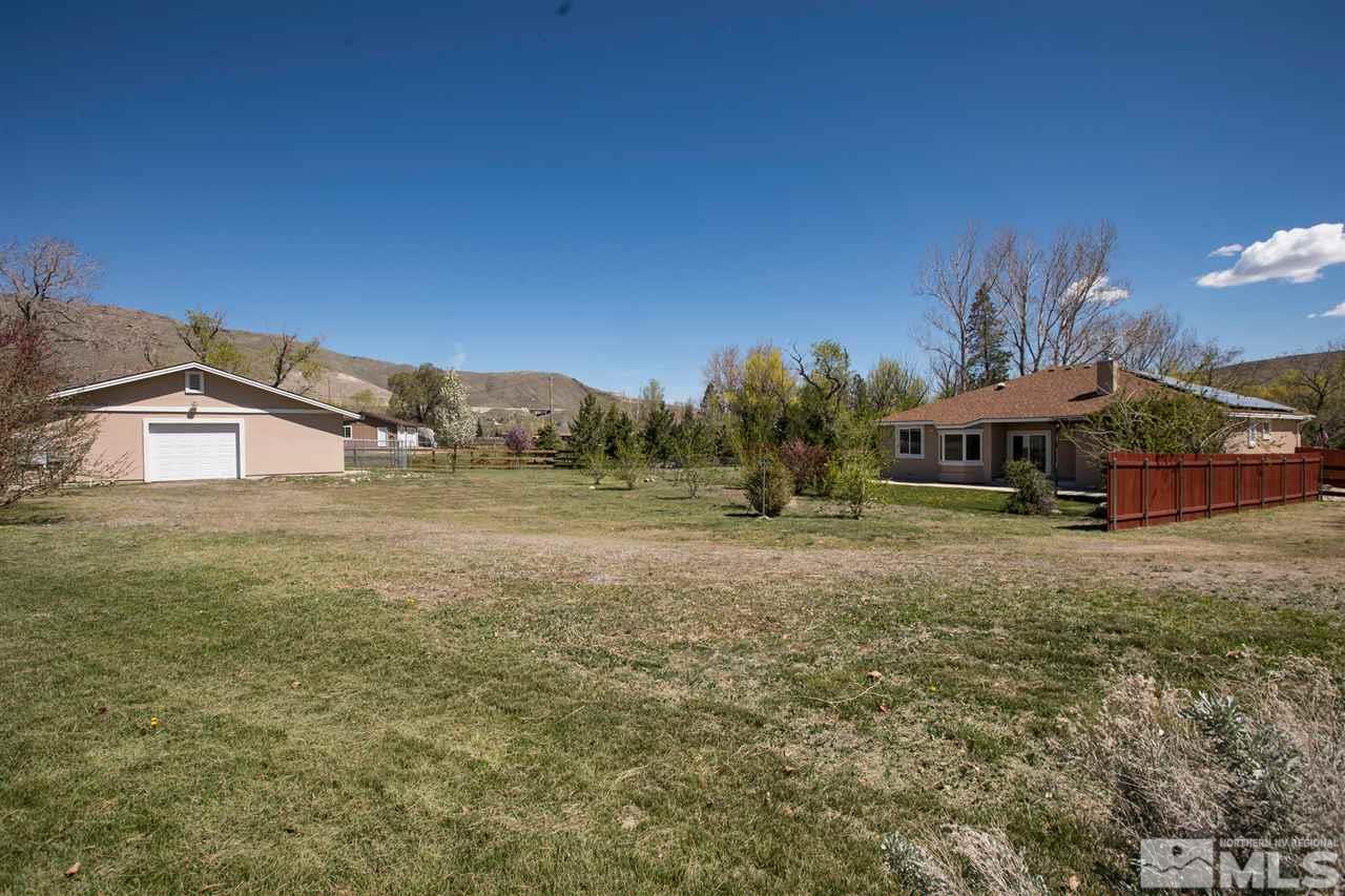 22925 Carriage Drive Reno, NV 89521 - Photo 22 of 24 a yellow house with trees in front of it