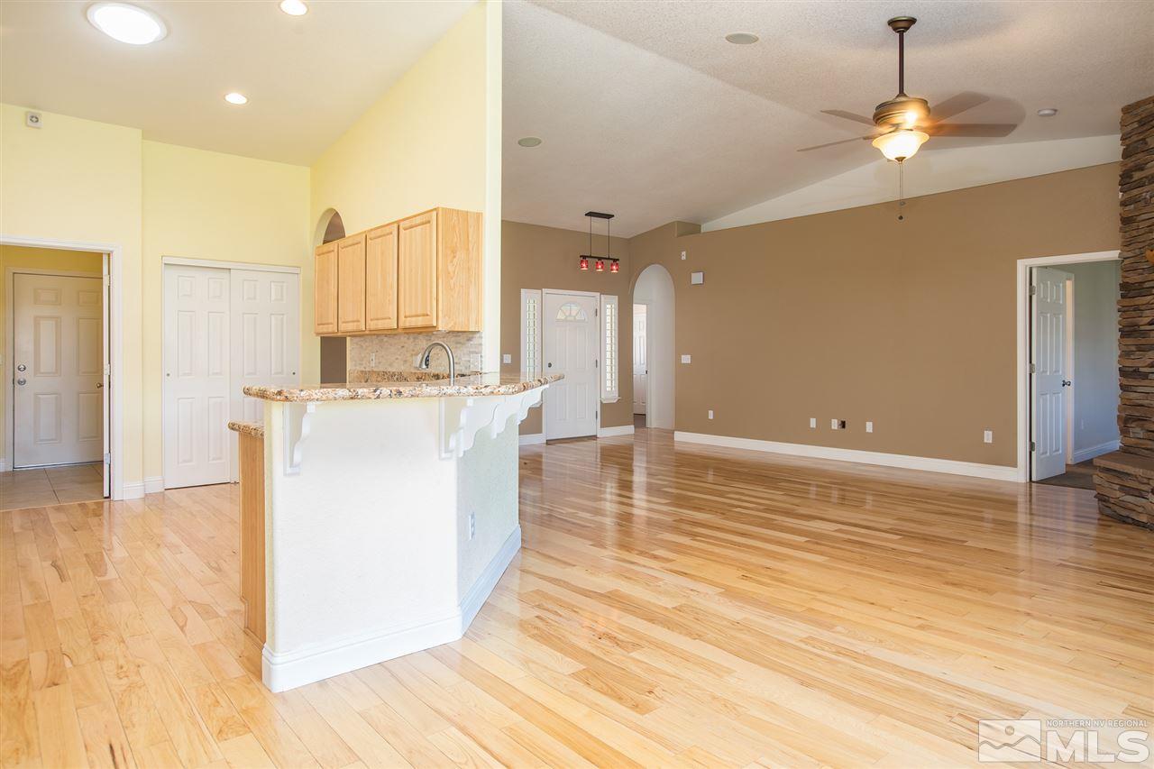 22925 Carriage Drive Reno, NV 89521 - Photo 8 of 24 a kitchen with stainless steel appliances granite countertop a sink a stove and a wooden floors