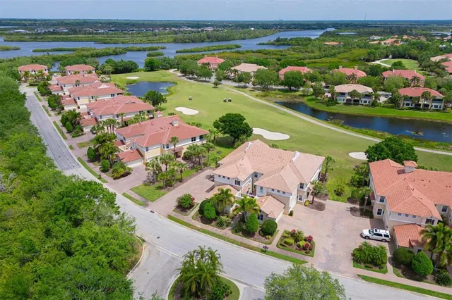 an aerial view of a city with lots of residential buildings lake and ocean view