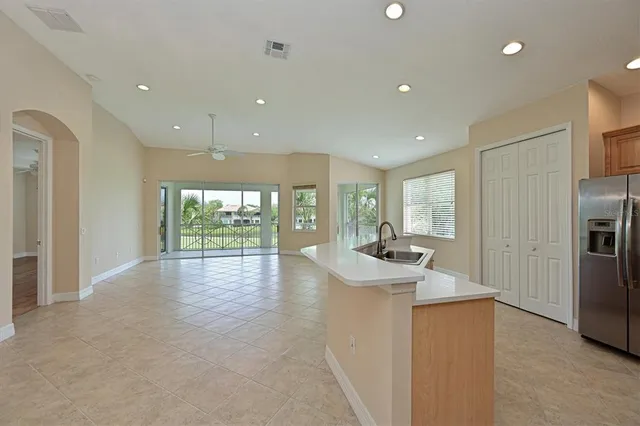 a kitchen with stainless steel appliances granite countertop a refrigerator and a sink